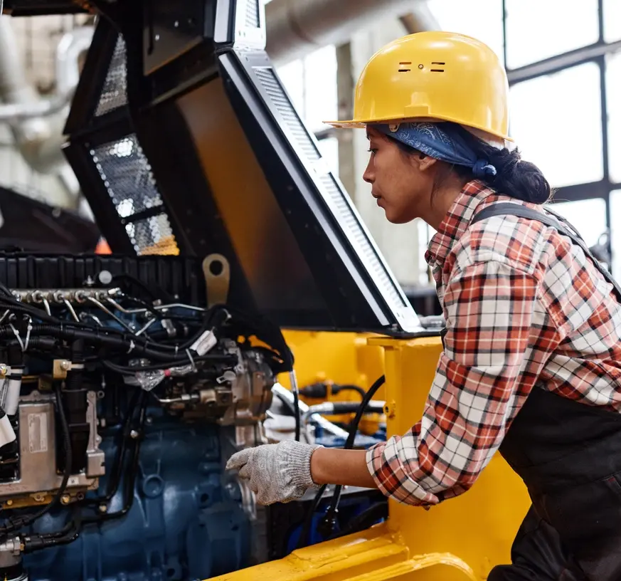 A woman operates heavy machinery.